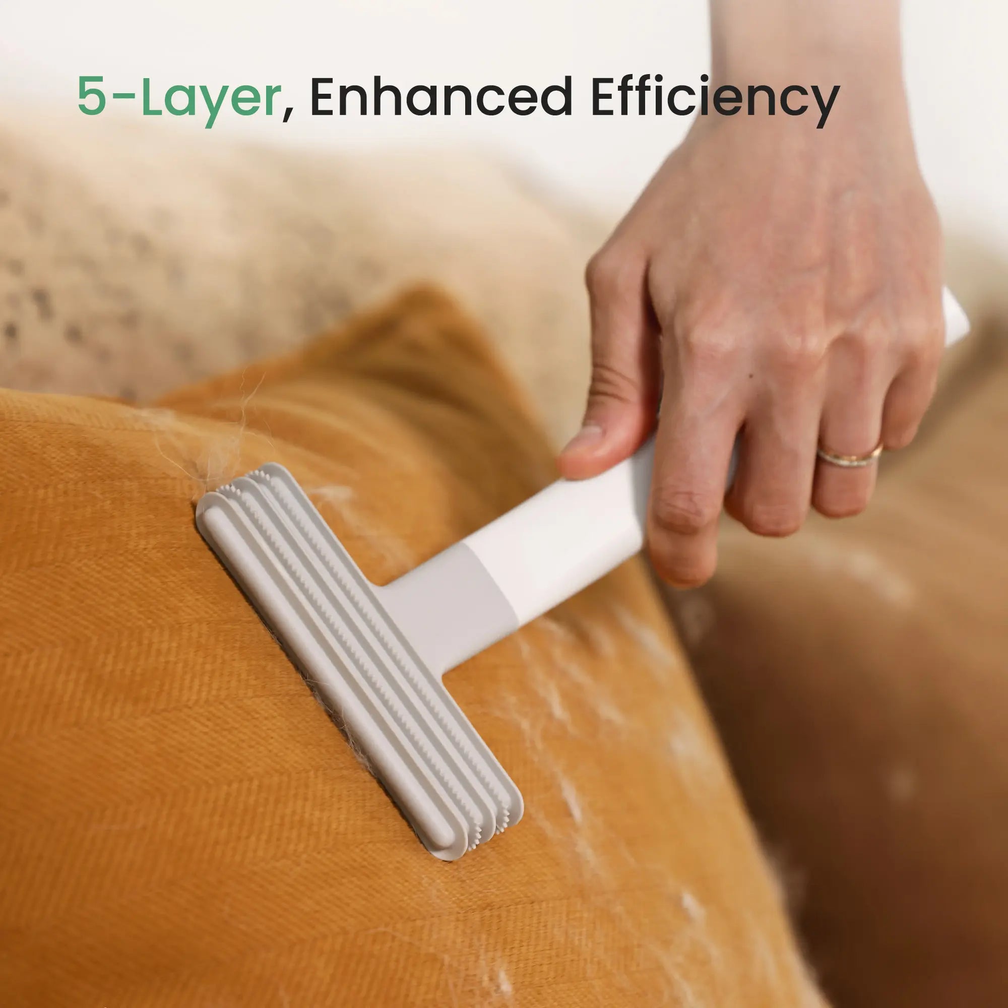 5-layer enhanced efficiency dancemoon Layer Brush removing cat hair from a pillow, leaving the cleaned area hair-free.